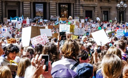 A group of people gathered holding signs for climate action