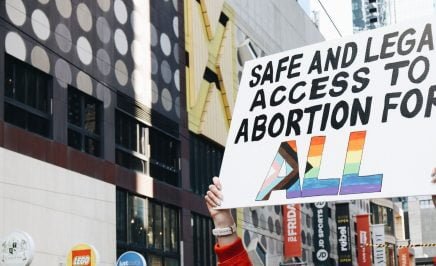 A protester holds a sign that reads 