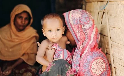 Rohingya child and his mother in a refugee camp